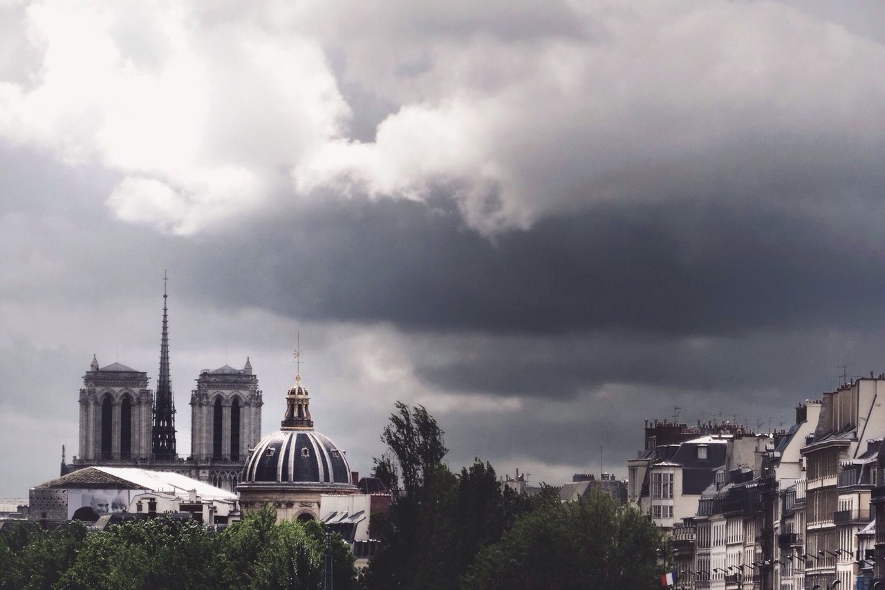 building exterior, architecture, built structure, sky, cloud - sky, cloudy, city, low angle view, weather, cloud, tower, overcast, church, religion, place of worship, building, outdoors, residential building, day