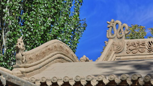 Low angle view of statue against sky