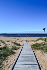 View of calm sea against clear blue sky