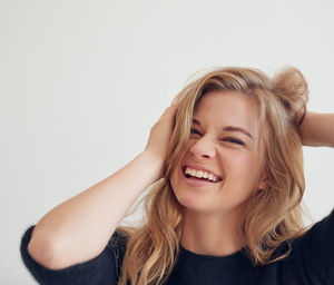 Portrait of young woman against white background