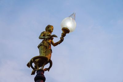 Low angle view of street light against sky