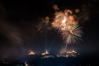 Low angle view of firework display at night