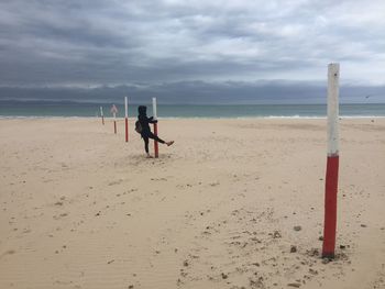 Man standing on beach against sky