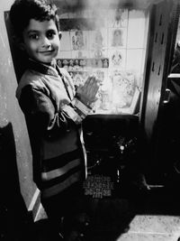 Portrait of smiling boy sitting at home