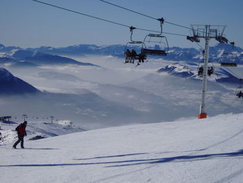 Tourists on snow covered mountain