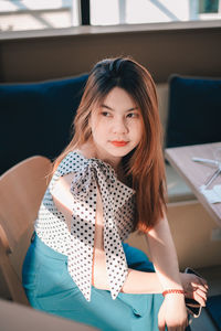 Portrait of young woman sitting in car