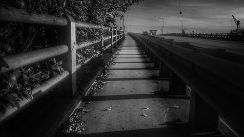 Footbridge over water against sky