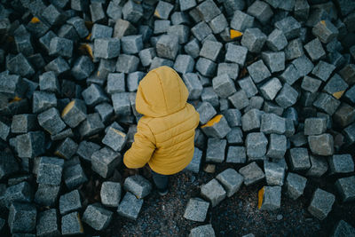 High angle view of child on  stones 