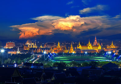 Illuminated city against sky at night