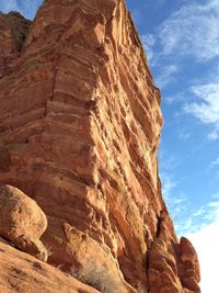 Low angle view of rock formation against sky