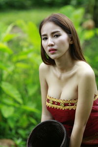 Portrait of young woman sitting outdoors