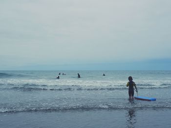 People on beach against sky