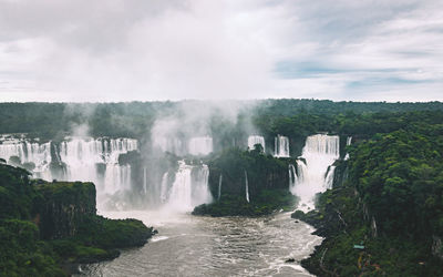 Scenic view of waterfall against sky