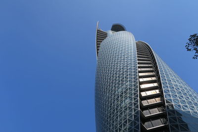 Low angle view of modern building against clear blue sky