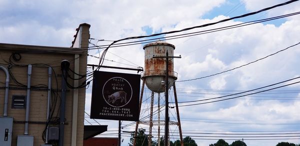 Low angle view of telephone pole against sky