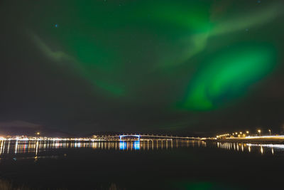 Scenic view of lake against sky at night