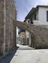 Alley amidst buildings in city against sky