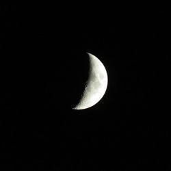 Low angle view of half moon against sky at night