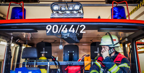 Firefighter taking call in truck