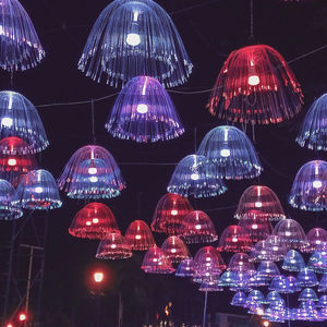 Low angle view of illuminated lanterns hanging at night