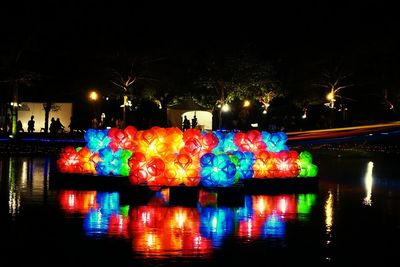 Illuminated firework display at night