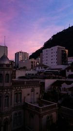 Buildings in city at sunset