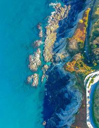 High angle view of rocks by sea