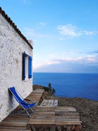 Built structure by sea against sky