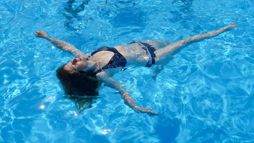 High angle view of woman swimming in pool