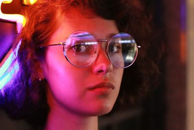 Close-up portrait of young woman wearing sunglasses