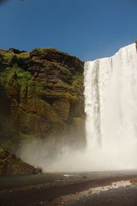 Scenic view of waterfall against clear sky