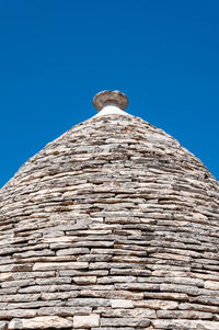 Low angle view of old building against blue sky