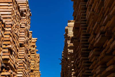 Low angle view of buildings against clear blue sky