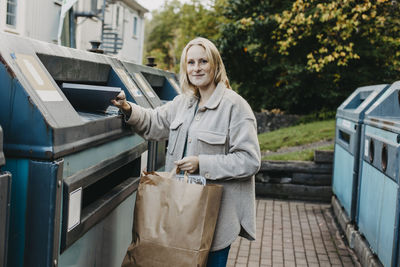 Woman recycling rubbish