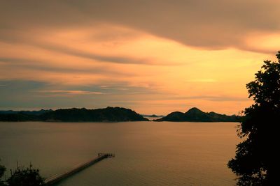 Scenic view of lake against orange sky