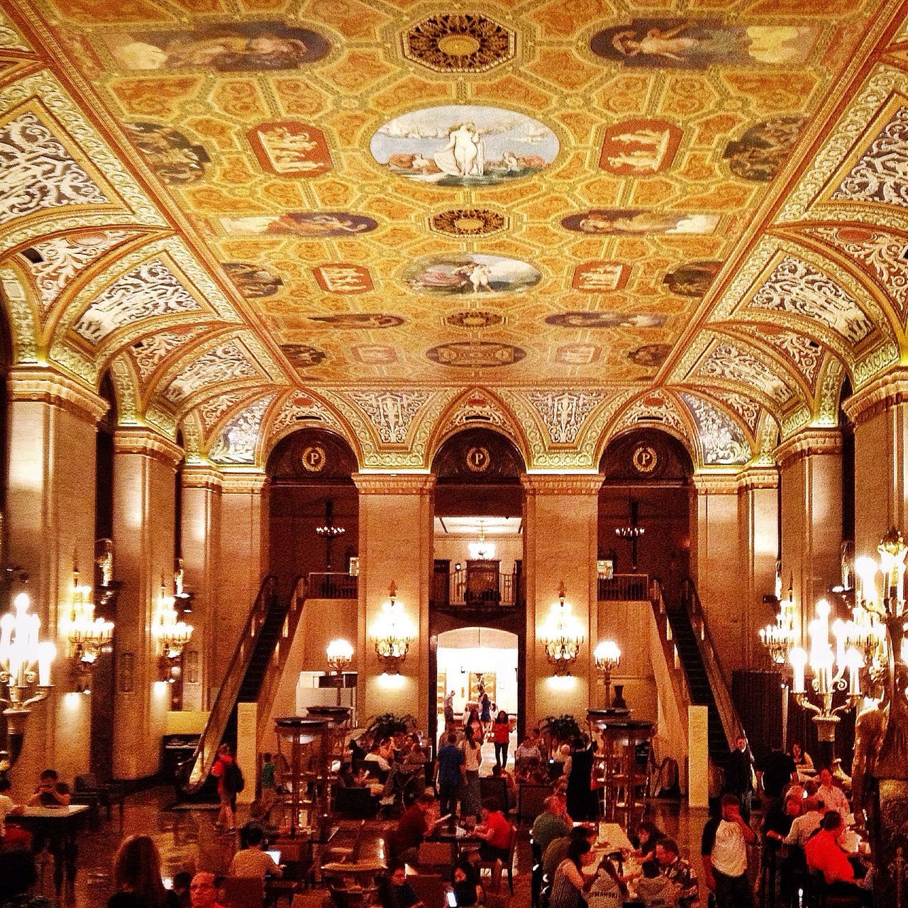 indoors, ceiling, large group of people, architecture, illuminated, arch, place of worship, religion, interior, famous place, travel destinations, built structure, person, tourism, travel, spirituality, men, chandelier