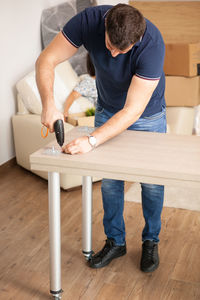 Low section of man working at workshop