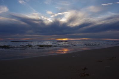 Scenic view of beach against sky during sunset