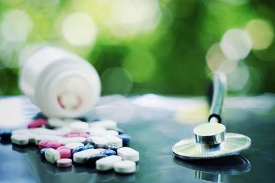 Close-up of medicine and stethoscope on table