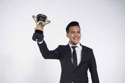 Portrait of a smiling young man against white background