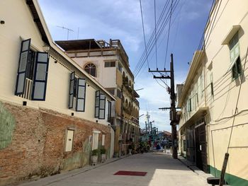 Street amidst buildings in city against sky