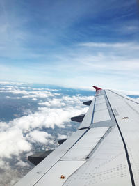 Cropped image of airplane wing against sky