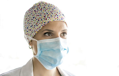 Young medical professional with procedure mask on her face