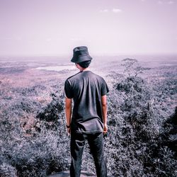 Rear view of man standing against sky