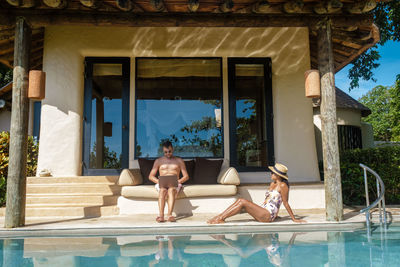 Side view of woman relaxing in swimming pool