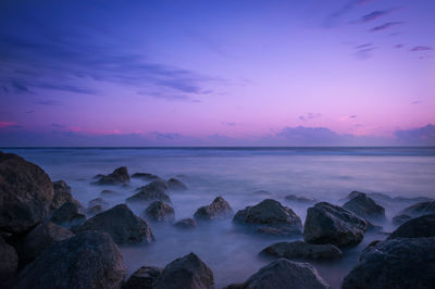 Scenic view of sea against clear sky at sunset