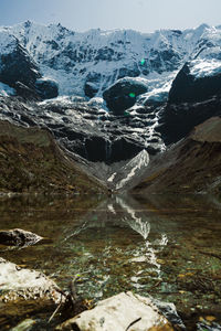 Laguna humantay with snow covered mountains in the background