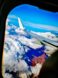 Aerial view of clouds seen through airplane window