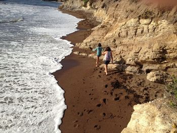 Full length of woman standing on rock