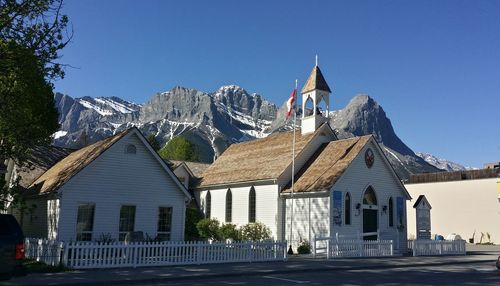 View of houses against blue sky